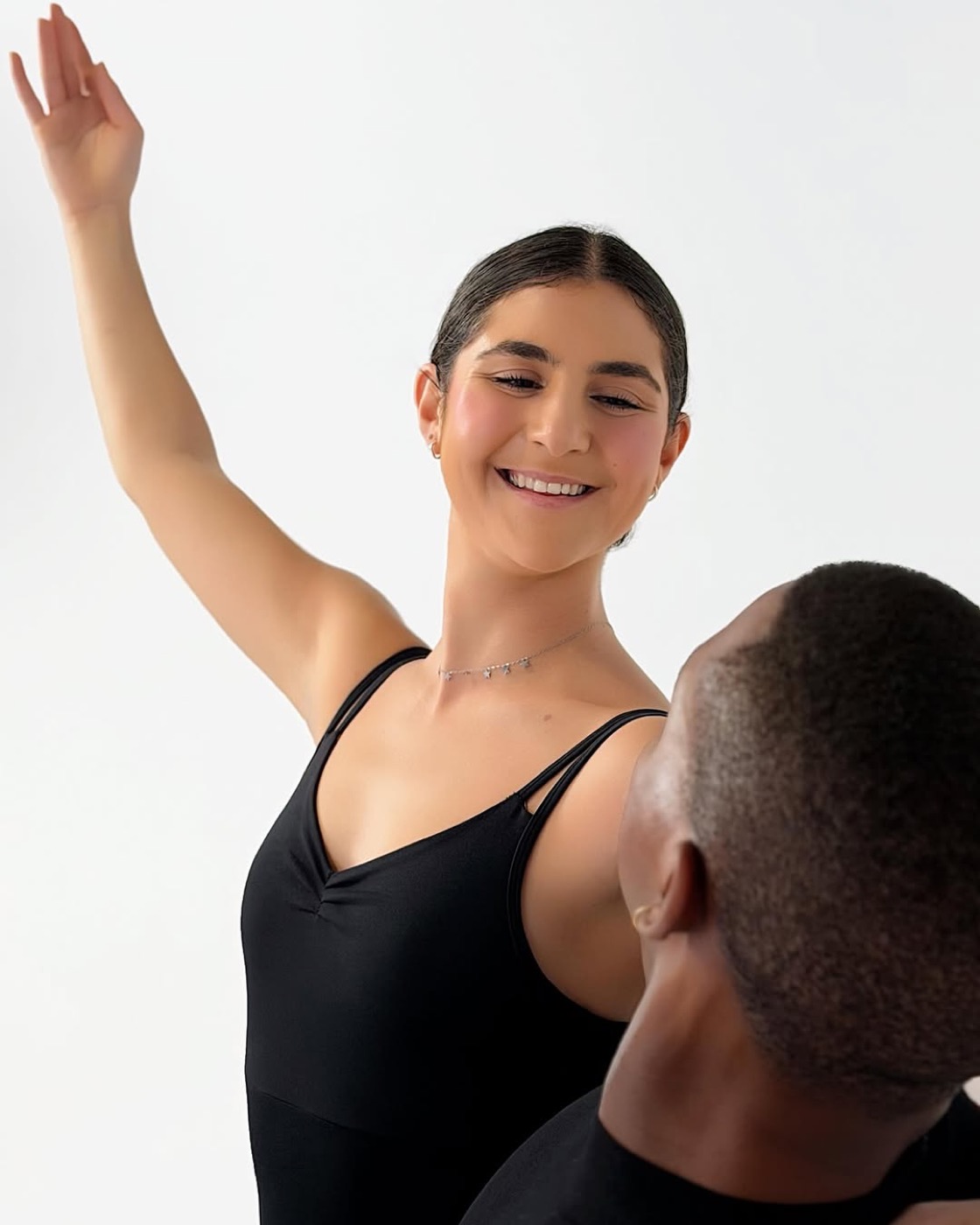 Ballet dancers mid-movement, studio